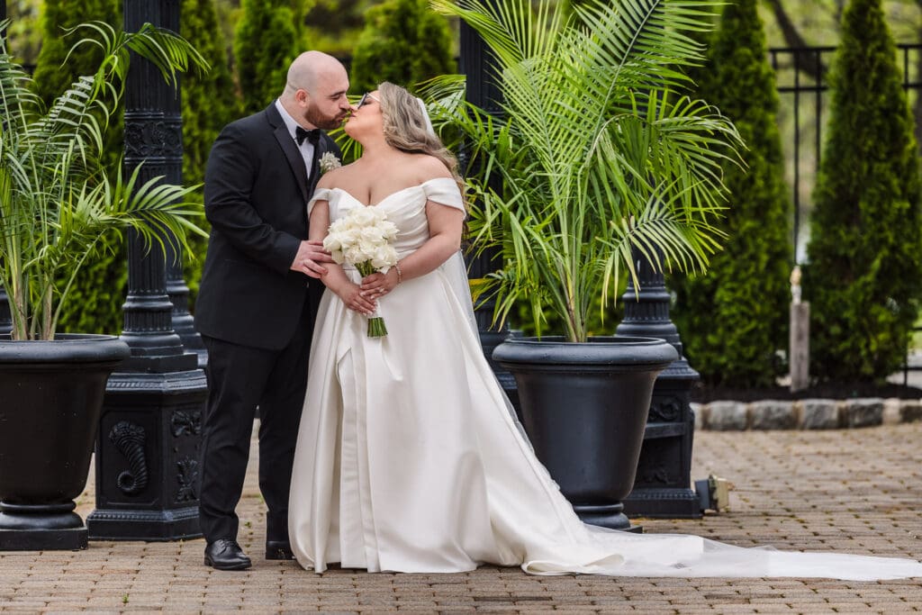 Bride and groom portrait at an elegant New Jersey wedding venue surrounded by greenery