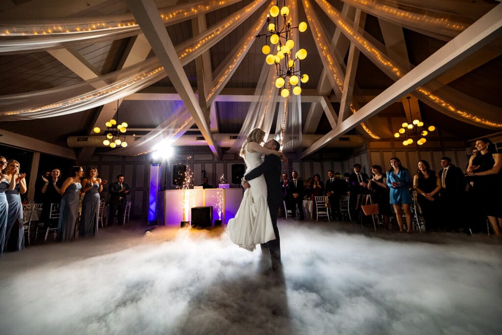 Romantic first dance at a New Jersey wedding reception with dramatic lighting and fog