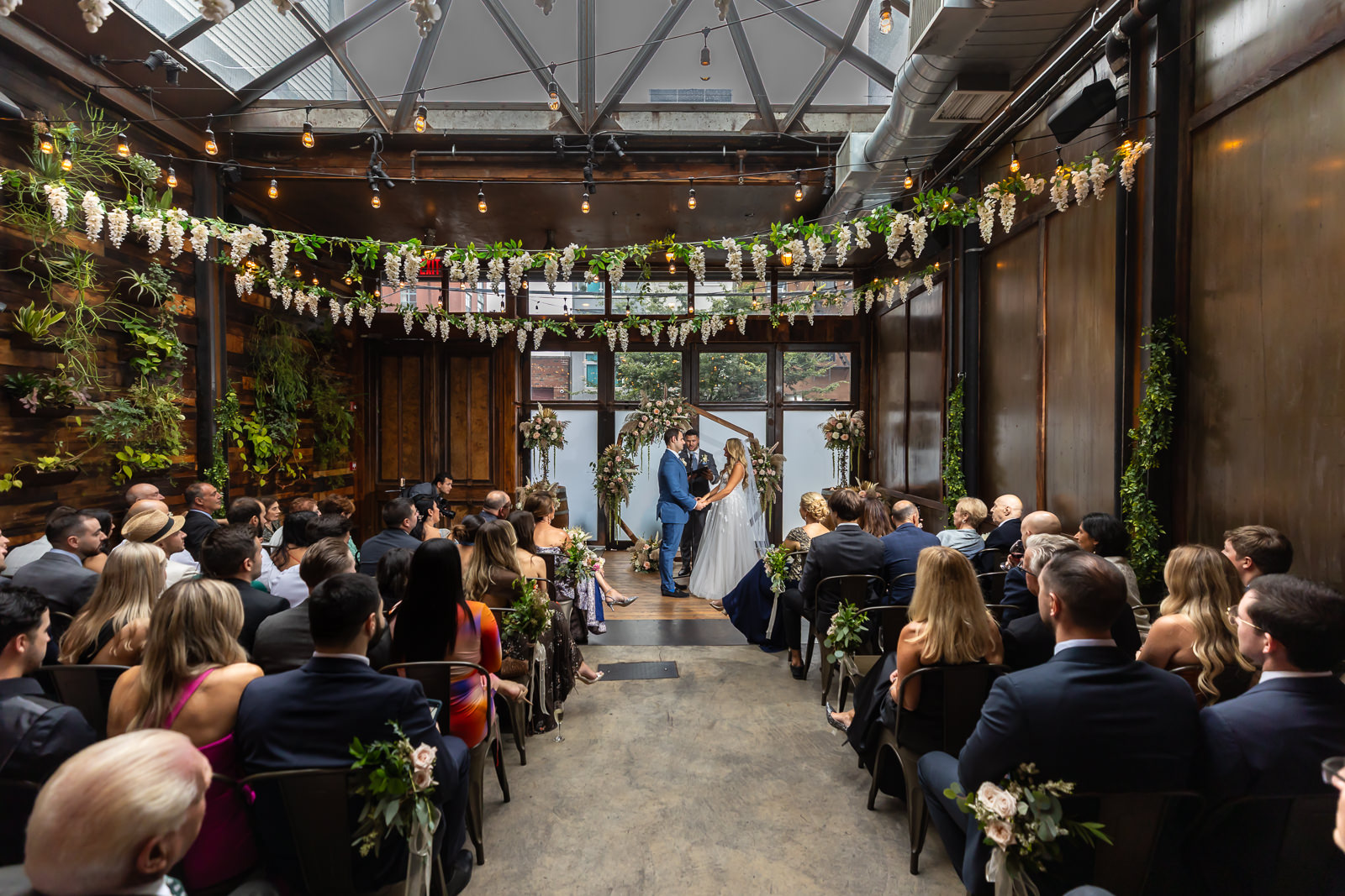 Wide view of wedding ceremony inside Brooklyn Winery in Williamsburg, Brooklyn.