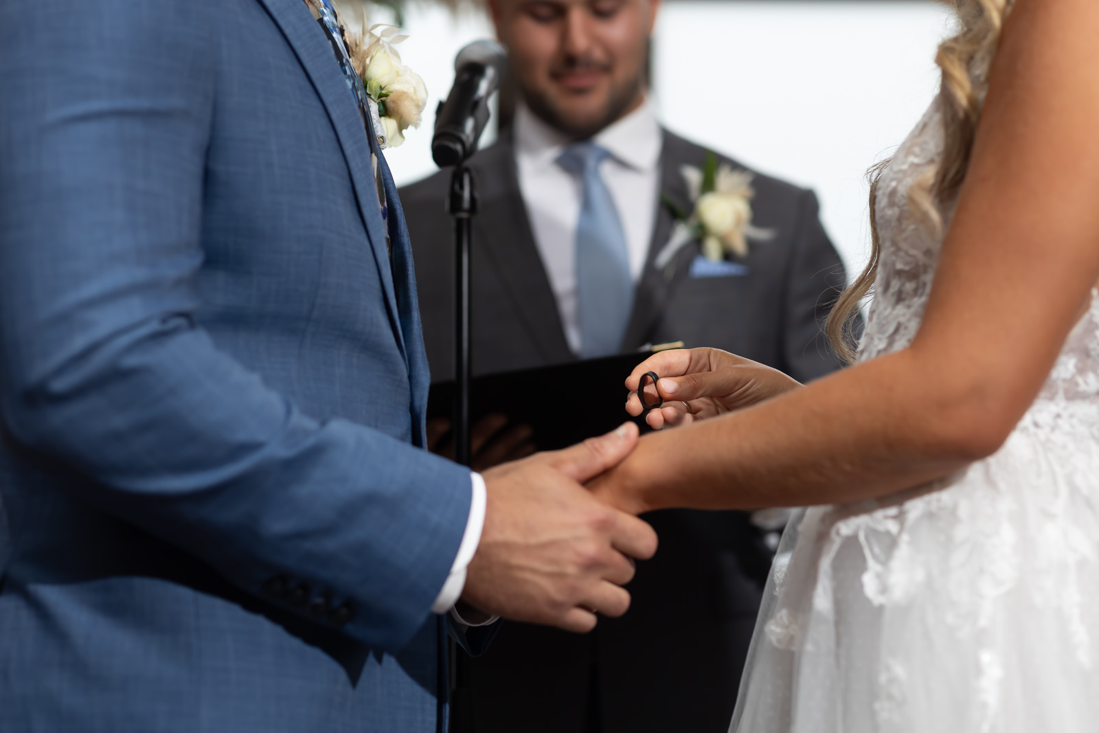 Close-up of wedding ring exchange during ceremony at Brooklyn Winery.