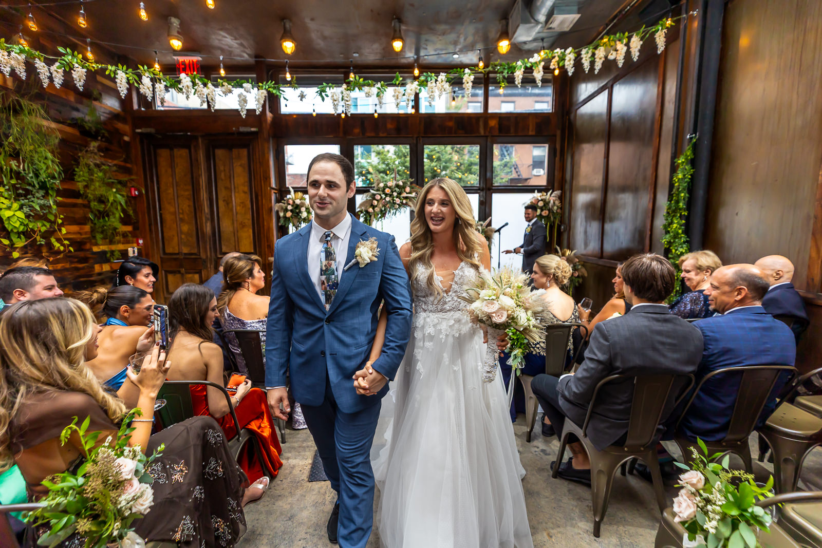 Couple walking down the aisle after being pronounced married at Brooklyn Winery.
