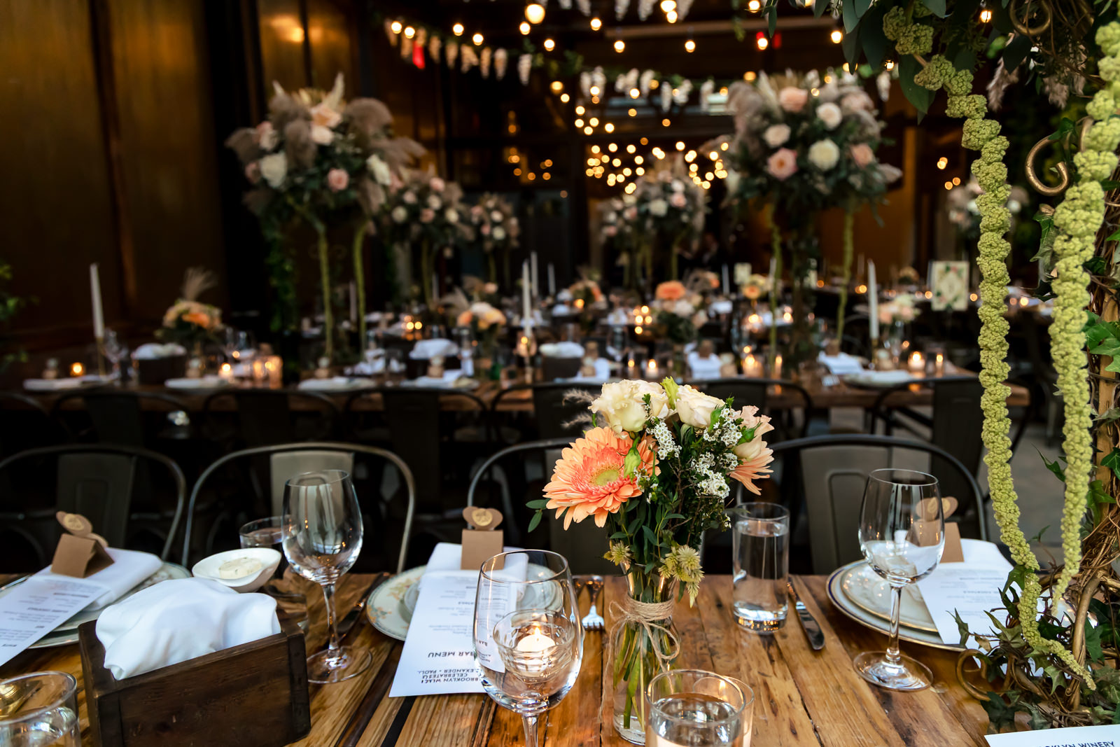 Reception tables and décor setup inside Brooklyn Winery.