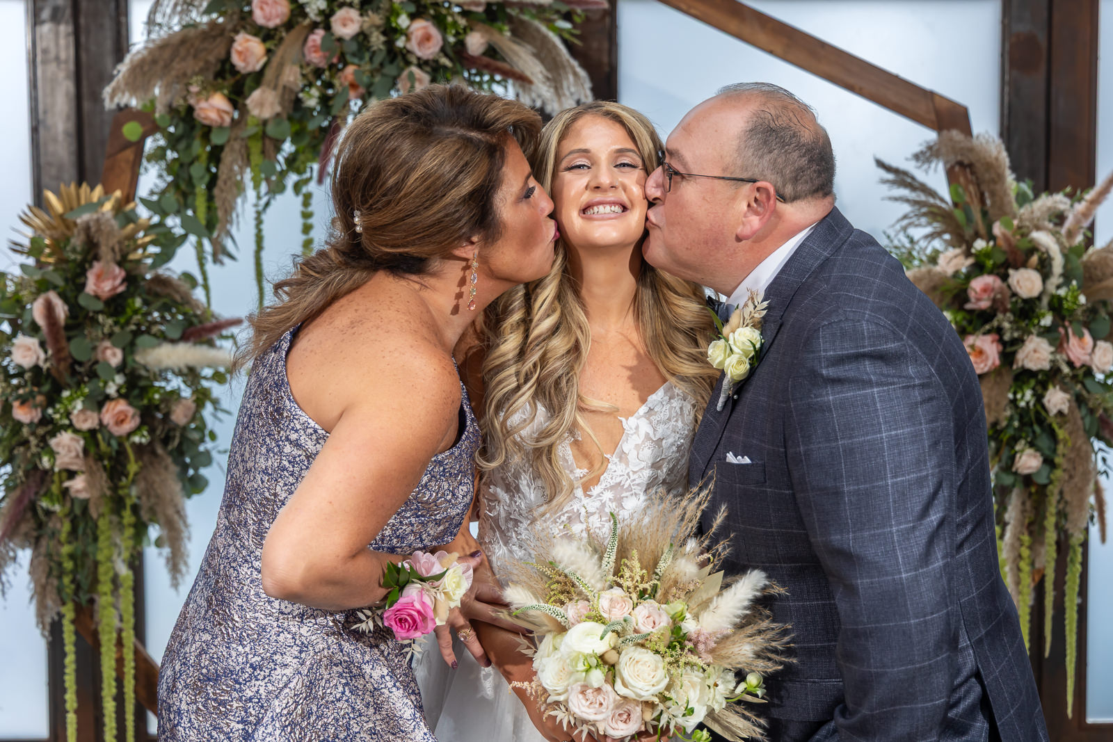 Bride smiling with family members during portraits at Brooklyn Winery.