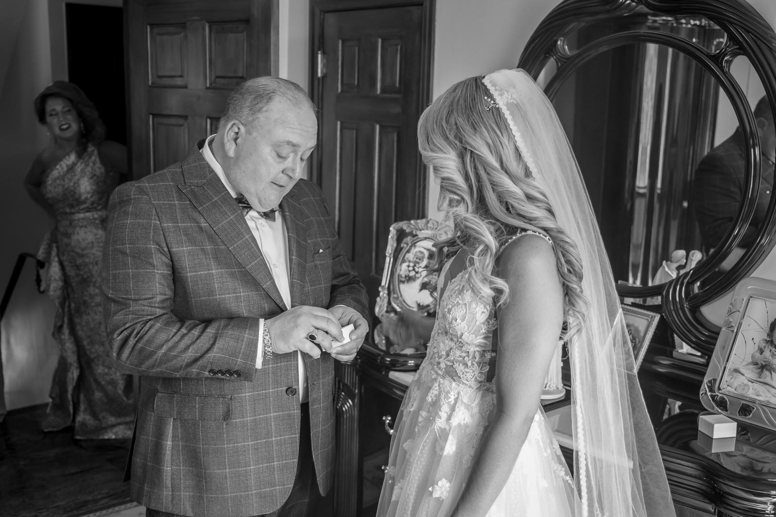 Emotional moment between bride and family member before ceremony.