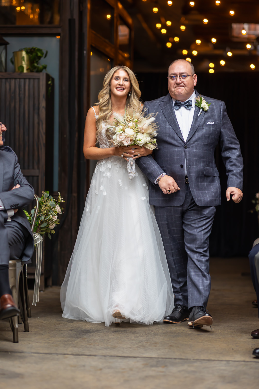 Bride walking down the aisle with her father during a Brooklyn Winery wedding ceremony.