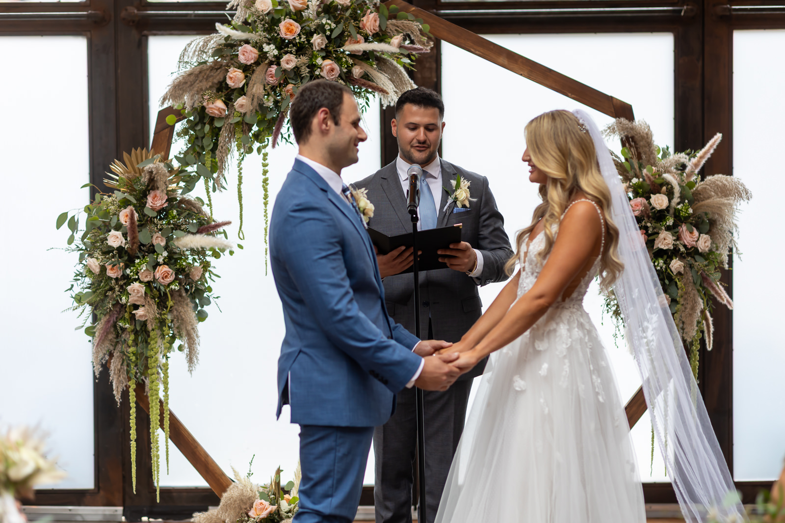Paola and Alex exchanging vows during their wedding at Brooklyn Winery.