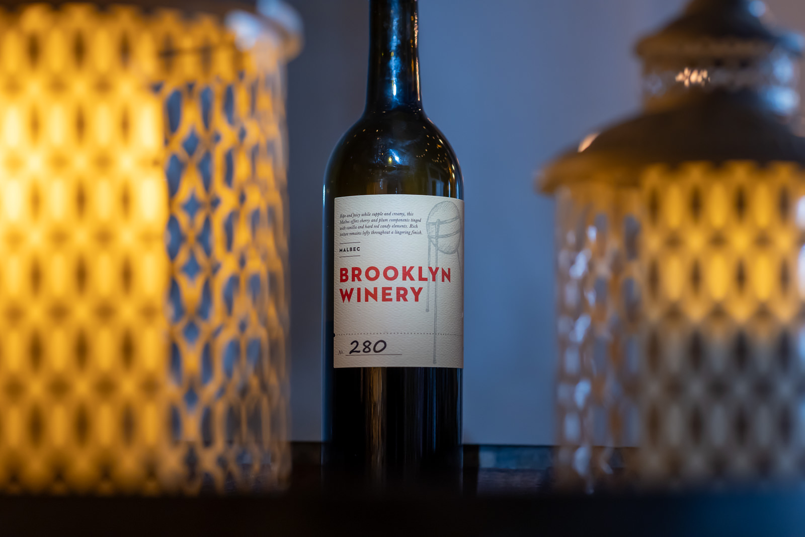 Brooklyn Winery wine bottle displayed among reception details and candlelight.