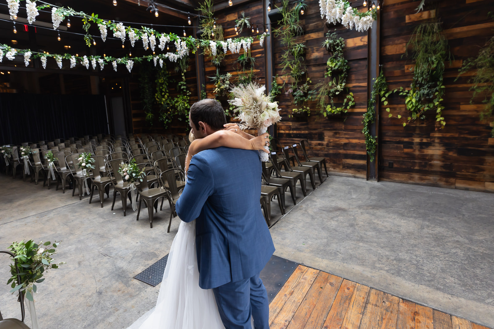 Paola and Alex embracing during their first look at Brooklyn Winery.